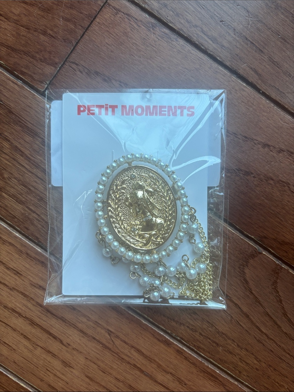 Petit Moments Gold Pearl Medallion brooch pin.
